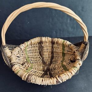 Vintage handwoven basket with brown and green yarn details and eye of God.